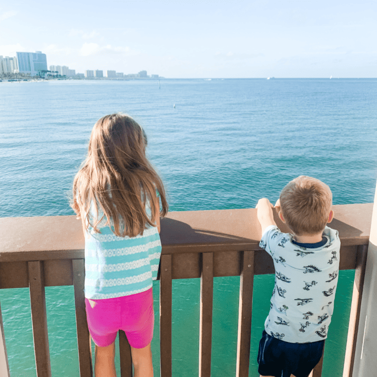 Photo of two kids on Pier 60 in Clearwater Beach, Florida looking out over the Gulf of Mexico.